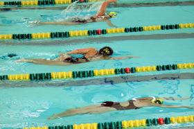 Swimmers racing freestyle at Green and Gold.