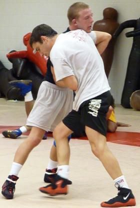 Porcher (front, blue shorts) wrestles a teammate i