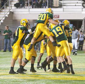 The Wildcats celebrate a touchdown in 2010.