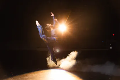 Student dancer performing on stage at NMU