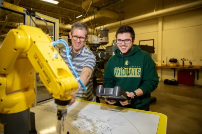 Robotics student and professor working