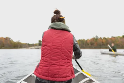Female student conducting research from a canoe