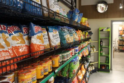 Potato chip bags and chip dip on shelves in Cat Trax