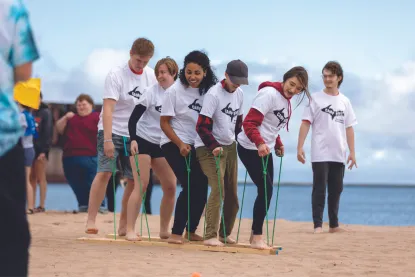 Students on the beach competing in games
