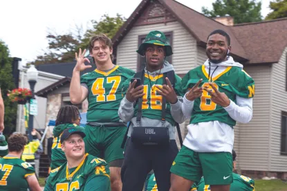 NMU Football players in the homecoming parade