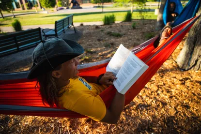 Student studying in a hammock