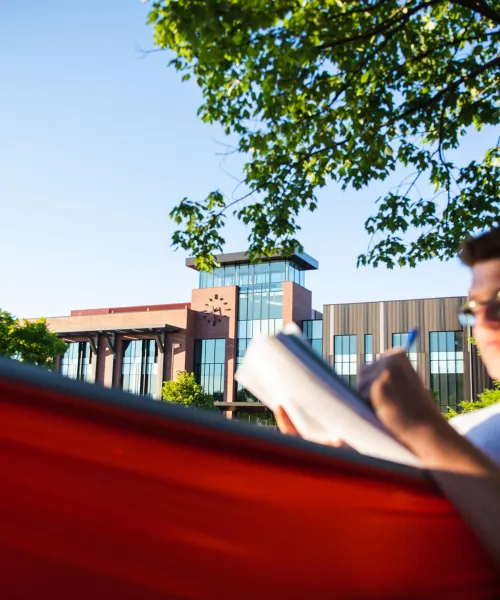 Student hammocking in front of Jamrich