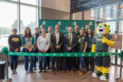 President Tessman standing with a group of people at the ribbon cutting ceremony