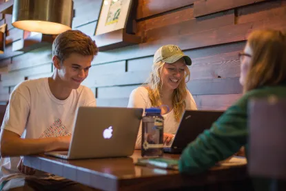 Students studying on laptops in a Starbucks