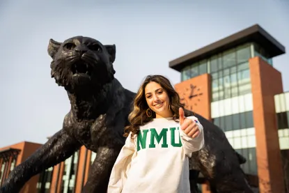 Student with Thumbs Up in Front of Wildcat Statue and Jamrich