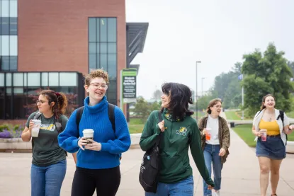 five students walking on NMU's campus