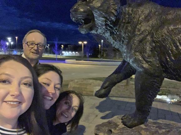 A selfie of the Young family by the wildcat statue on campus