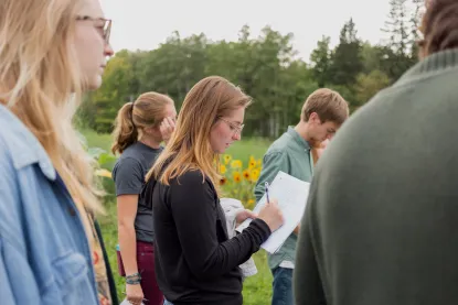 Group of students taking notes at an outside field trip