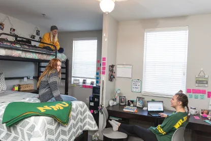 Three students in NMU residence hall room
