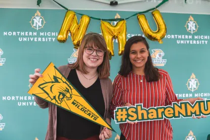 Two female students in an NMU photo booth