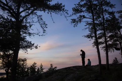 Students on a mountain at sunset