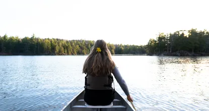Student (female) in a canoe. 