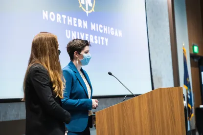 Students speaking at a podium