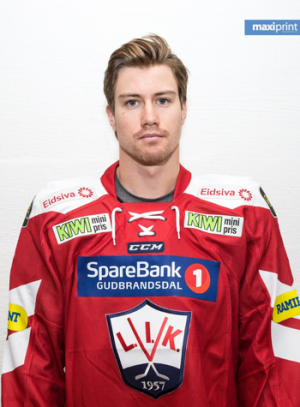 Stephan Vigier: A man wearing a red and white jersey stands in front of a white background.