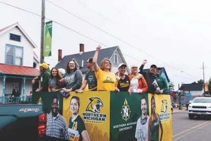 NMU Alumni on homecoming float in the parade