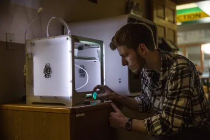 Student using a 3D printer