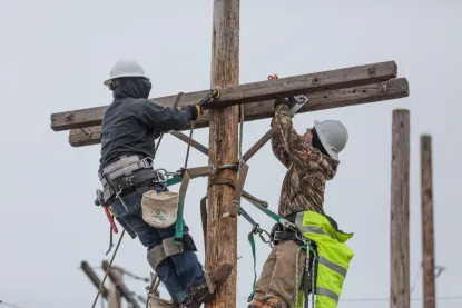 two students working on a power line