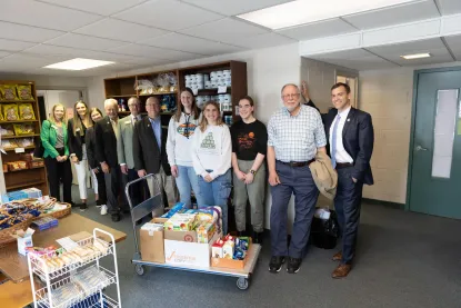 board members with students at the NMU food pantry